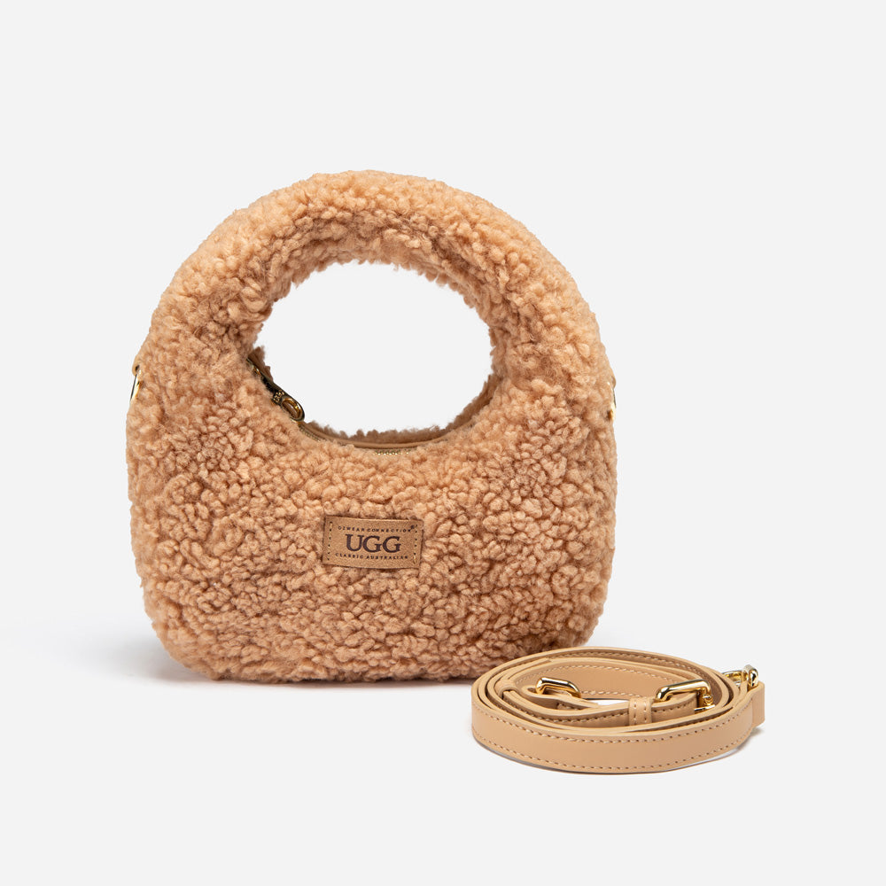 Beige UGG shearling handbag with a strap on a light gray background